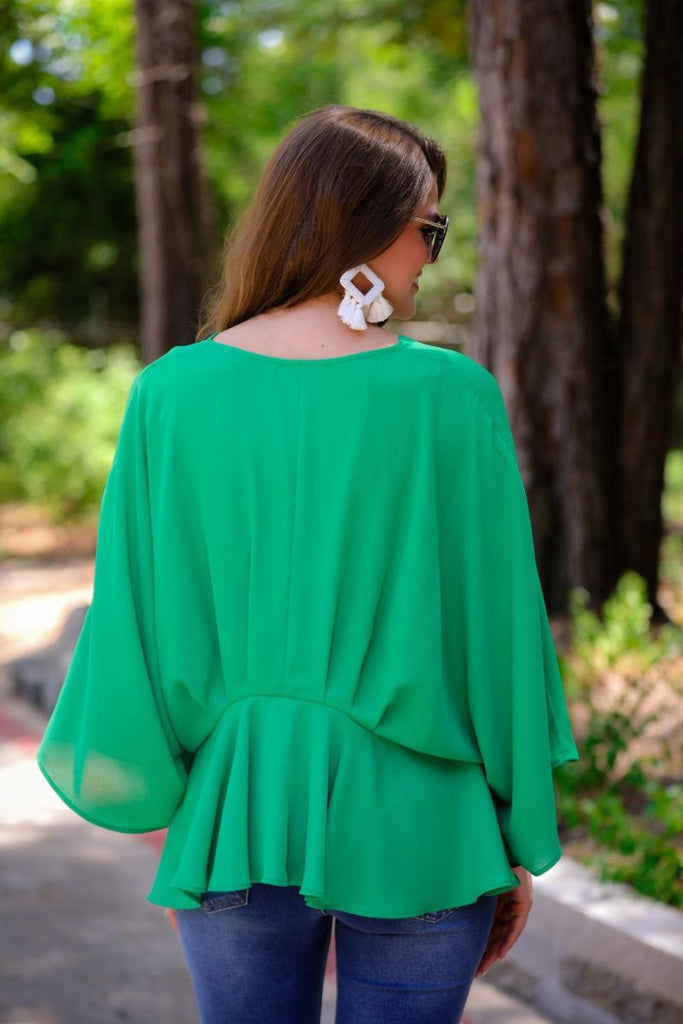 dolman long sleeves top with a plunging v-neckline and a gathered waistline in green