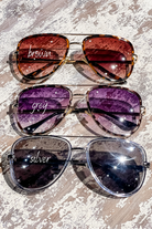 brown, grey, and silver aviator sunglasses with thin round wireframes, tinted lenses, UV protection, and brand name detail (on both the temple and the complimentary black pouch)