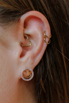 stud earrings in the shape of a gold happy face surrounded by sparkling rhinestones