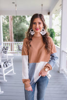 long-sleeve sweater with a rolled collar and a tri-colorblock of heather gray, ivory, and mocha