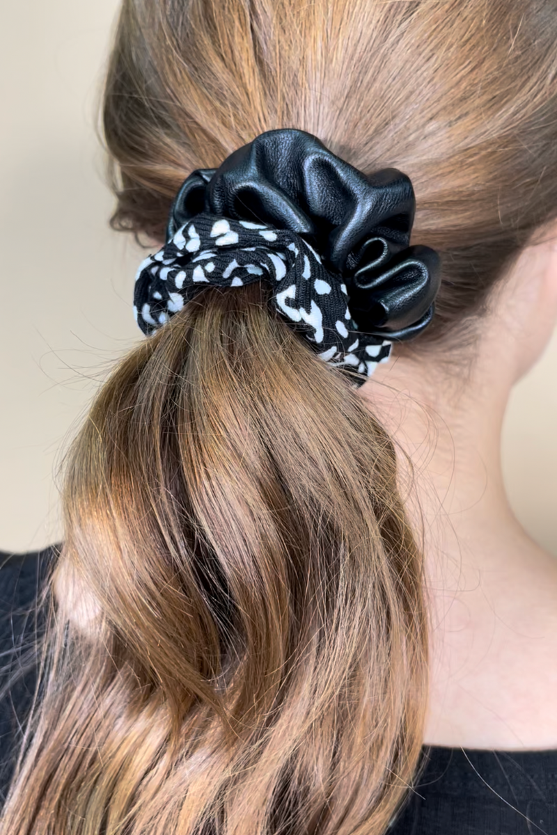 a classic pleather scrunchie paired with bold animal print and elastic in black