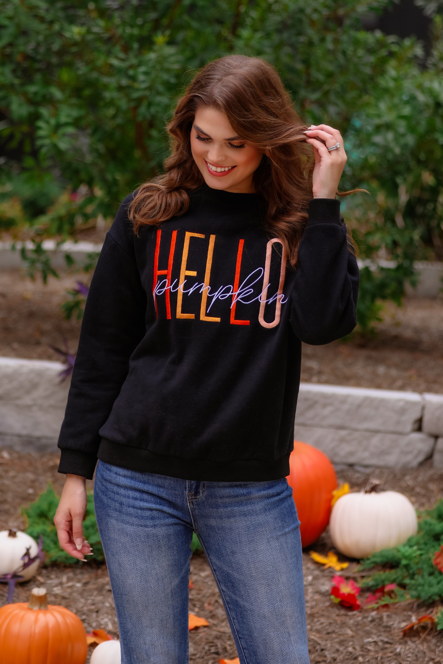 long sleeves black sweatshirt with colorful HELLO embroidered under white cursive PUMPKIN