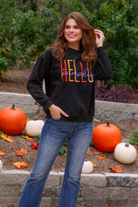 long sleeves black sweatshirt with colorful HELLO embroidered under white cursive PUMPKIN