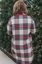 a long-sleeve shacket with a festive plaid print, cuffs, a button-down front to a high-low split hem, a collared neckline, button-closure chest pockets, convenient side pockets on a seasonal plaid print warm fabric