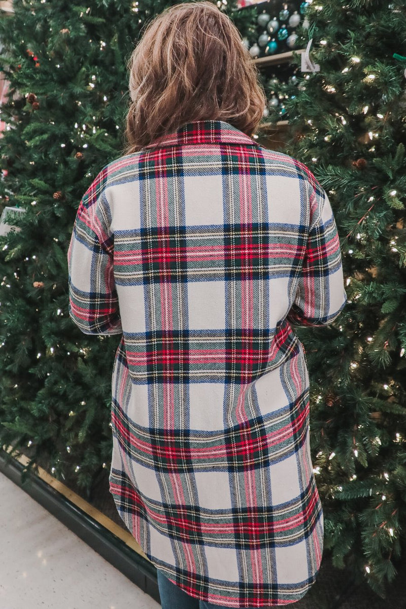 a long-sleeve shacket with a festive plaid print, cuffs, a button-down front to a high-low split hem, a collared neckline, button-closure chest pockets, convenient side pockets on a seasonal plaid print warm fabric