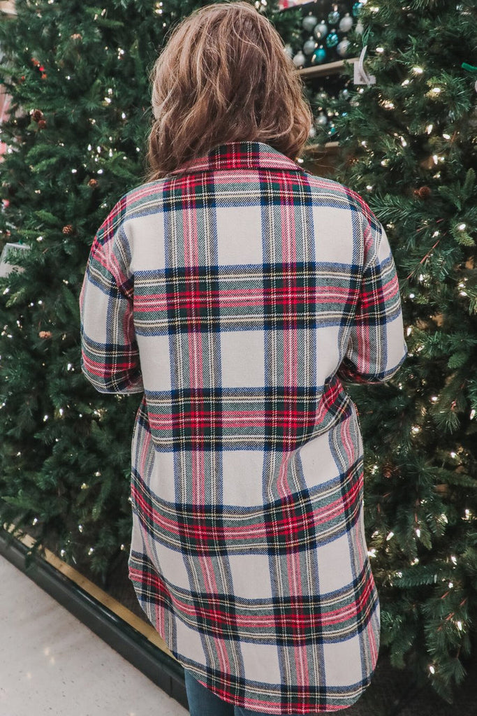 long-sleeve shacket with a festive plaid print, cuffs, a button-down front to a high-low split hem, a collared neckline, button-closure chest pockets, convenient side pockets on a seasonal plaid print warm fabric