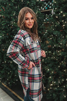 a long-sleeve shacket with a festive plaid print, cuffs, a button-down front to a high-low split hem, a collared neckline, button-closure chest pockets, convenient side pockets on a seasonal plaid print warm fabric