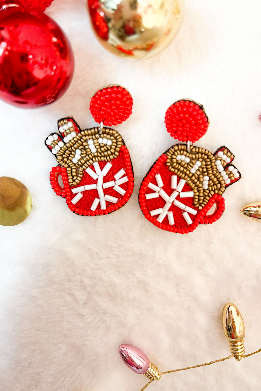 a red mug with a snowflake, cocoa, and marshmallows on a red beaded post stud, comfort replacement earring back, a plastic disk stopper style in silver, and felt backing in khaki