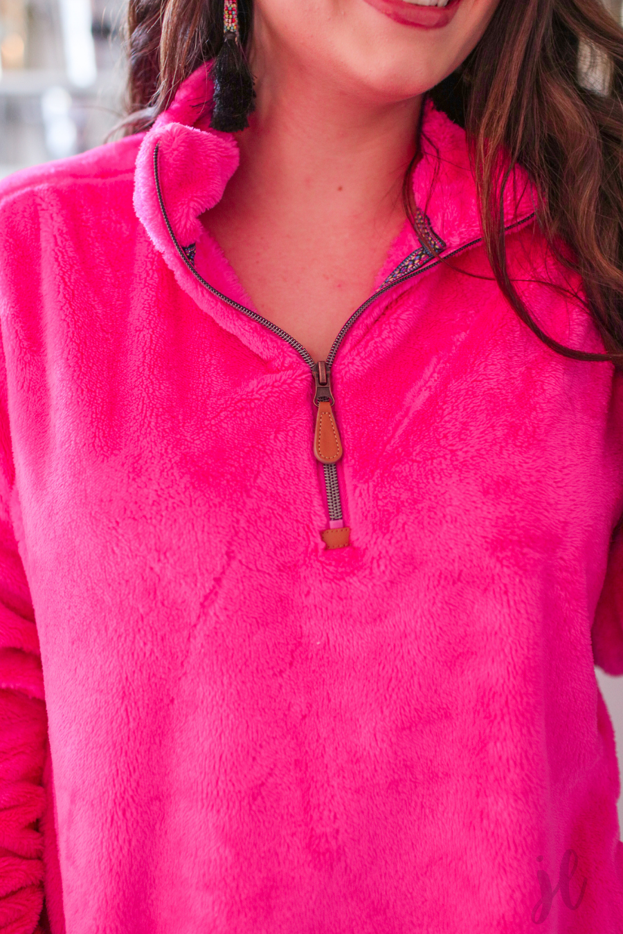 long-sleeve plush fleece pullover with quarter zip, front pockets, and a foldable collar on a super soft hot pink fabric