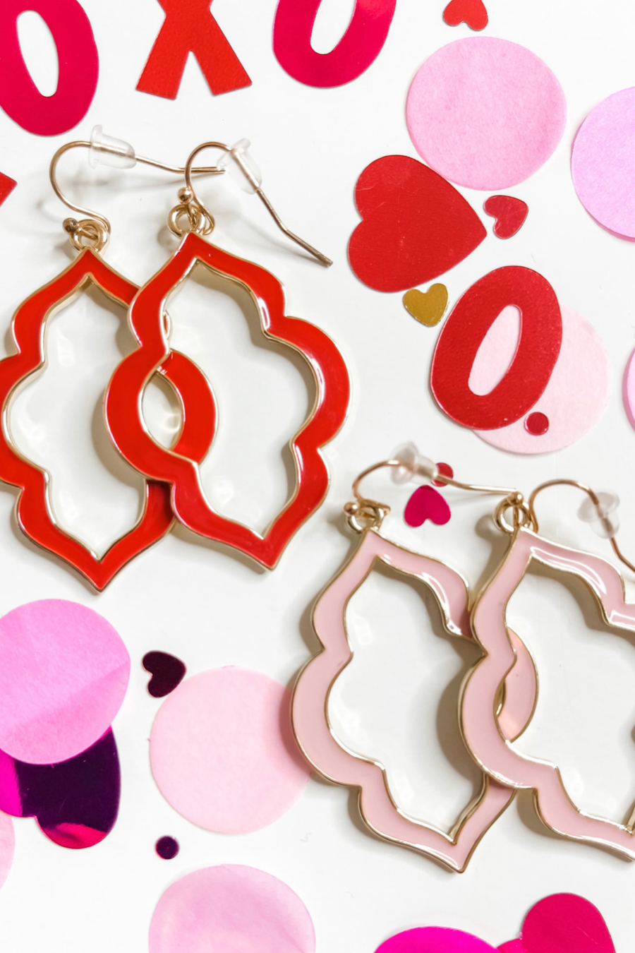 quatrefoil-shaped hook earrings with colored enamel centers in pink and red