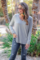 long sleeve tee with a v-neckline and a rounded hemline that fits slightly oversized with a relaxed fit in grey