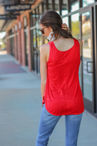 a sleeveless style, a v-neck neckline, side slits, a back center seam, and a rounded hi-lo hemline