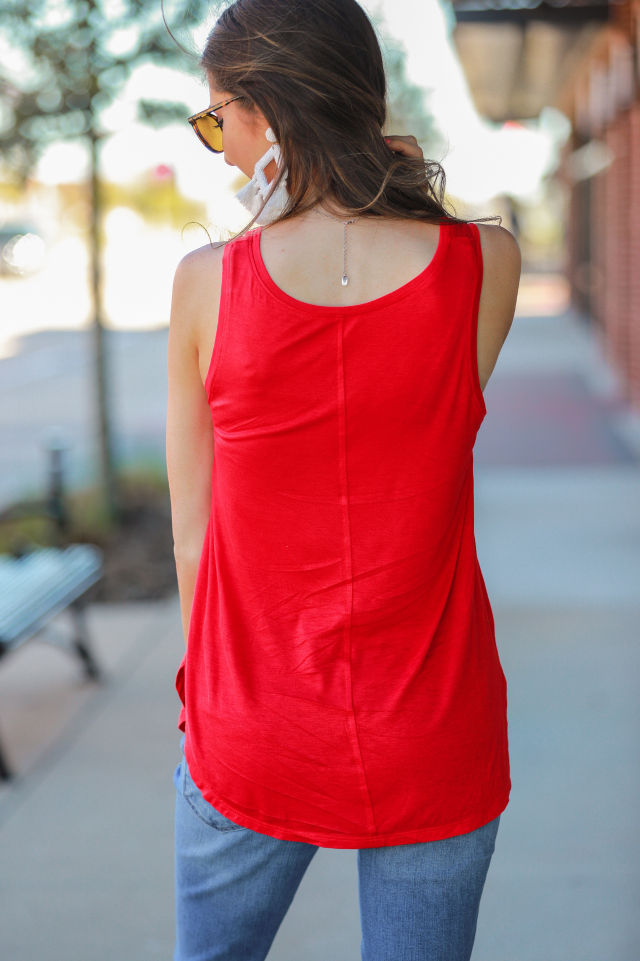 a sleeveless style, a v-neck neckline, side slits, a back center seam, and a rounded hi-lo hemline