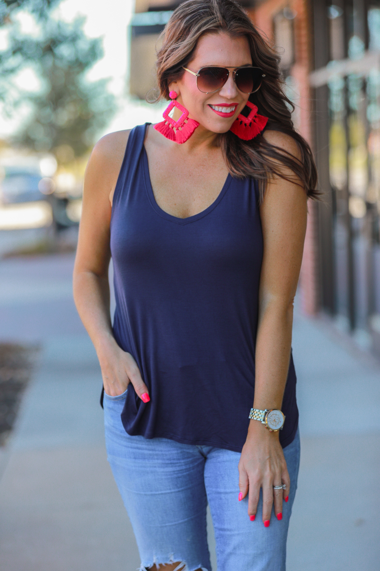 a sleeveless style, a v-neck neckline, side slits, a back center seam, and a rounded hi-lo hemline