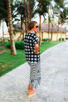 lightweight material patterned with checkered and horizontal stripes and a ruffled hemline