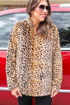 a long-sleeve fluffy pullover with a quarter zip and a foldable collar on a brown leopard fabric that fits oversized