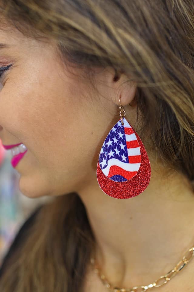 layered teardrop fishhook back earrings adorned with one small drop (American flag teardrop and white felt backing), one large double-sided glitter drop, and gold accents