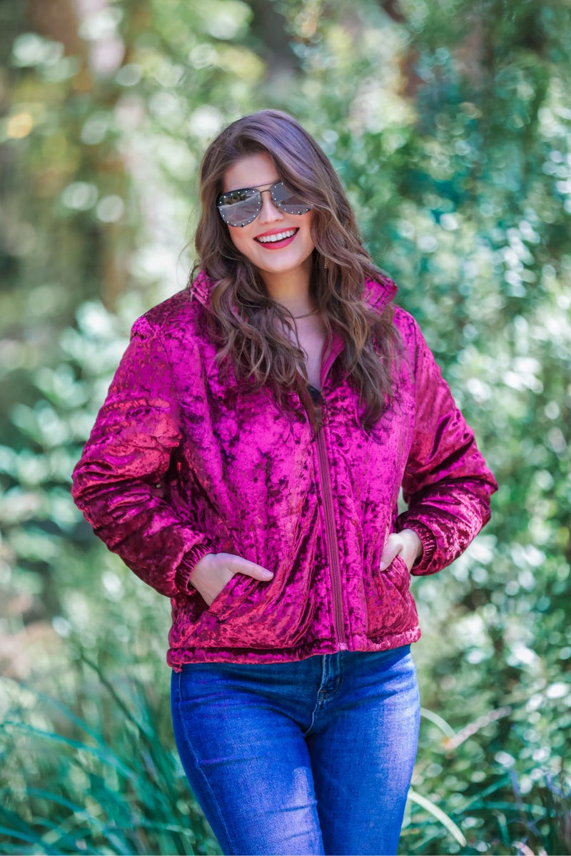 long-sleeve zip front closure jacket with a collar, side pockets, and adjustable drawstring hems made of lightweight material in wine color