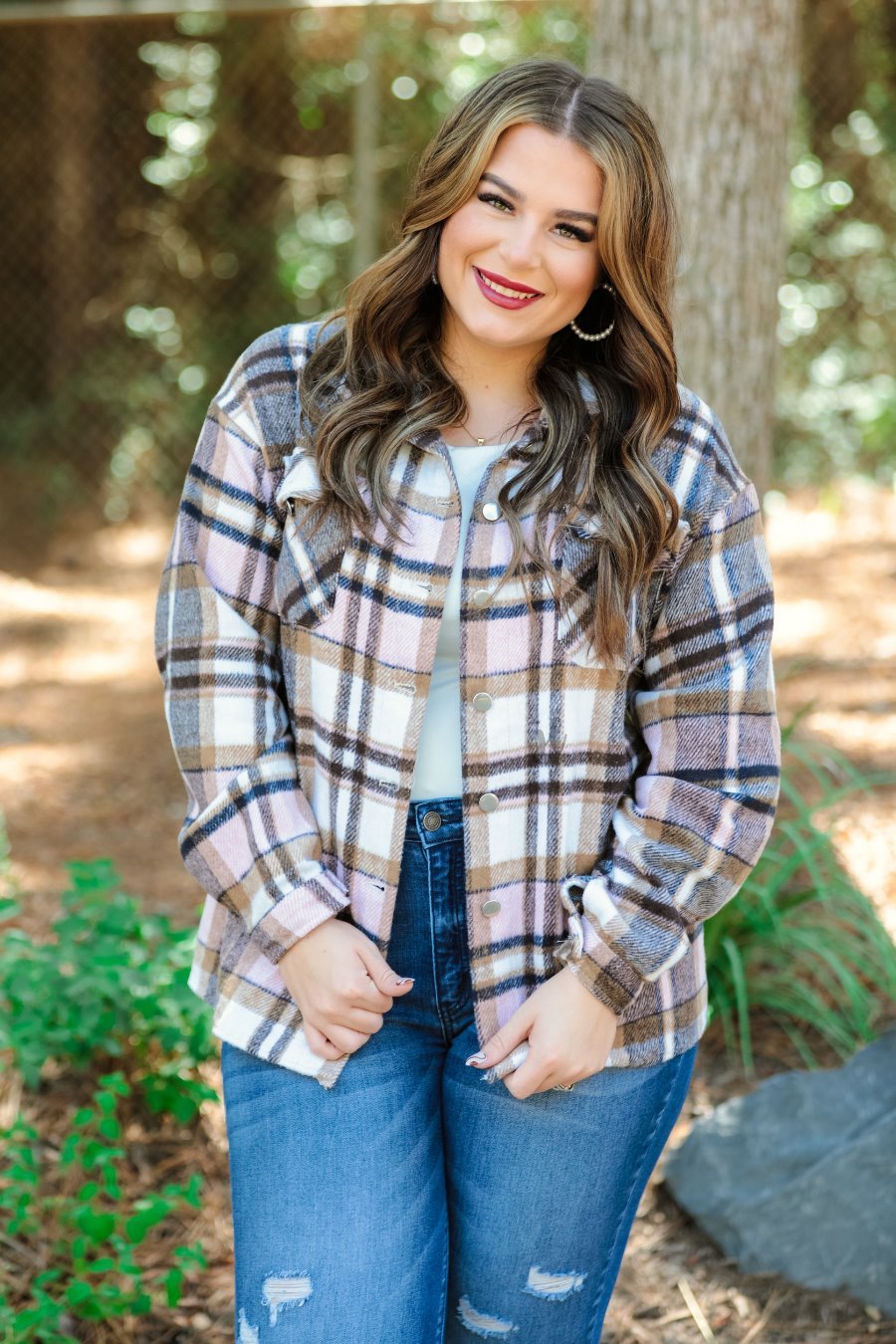 long-sleeves with fitted button closure cuffs, a button-down front, and a collared neckline on a tan plaid print