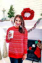 a red long-sleeve tunic made from comfy material with comfy material with a sublimation-printed Christmas pattern print (geometric designs, reindeer, Santa's sleigh, snowflakes, and trees) sublimation detail, ribbed accents (cuffs, neckline, and hem), side slits, and a relaxed fit