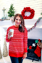 a red long-sleeve tunic made from comfy material with comfy material with a sublimation-printed Christmas pattern print (geometric designs, reindeer, Santa's sleigh, snowflakes, and trees) sublimation detail, ribbed accents (cuffs, neckline, and hem), side slits, and a relaxed fit