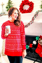 a red long-sleeve tunic made from comfy material with comfy material with a sublimation-printed Christmas pattern print (geometric designs, reindeer, Santa's sleigh, snowflakes, and trees) sublimation detail, ribbed accents (cuffs, neckline, and hem), side slits, and a relaxed fit