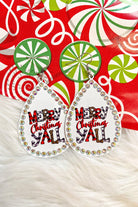 a fish hook back teardrop shape earring with a rhinestone outline and 'MERRY CHRISTMAS Y'ALL' written in alternating prints of red/black checkered, black/white checkered, brown leopard, and solid red