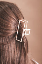a metal neutral rectangular claw clip with a secure hold that reduces breakage in peach