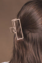 a metal neutral rectangular claw clip with a secure hold that reduces breakage in tan