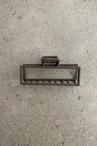 a metal neutral rectangular claw clip with a secure hold that reduces breakage in brown