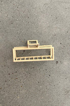 a metal neutral rectangular claw clip with a secure hold that reduces breakage in peach