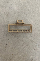 a metal neutral rectangular claw clip with a secure hold that reduces breakage in tan