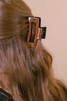 a metallic claw clip with a strong hold and sleek shine in rose gold