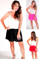 swing shorts with a relaxed fit, an elastic waistband, pocket-free design, breezy drape, and a skirt-inspired silhouette in black, pink, and red