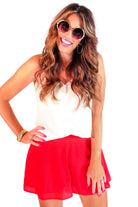 red swing shorts with a relaxed fit, an elastic waistband, pocket-free design, breezy drape, and a skirt-inspired silhouette