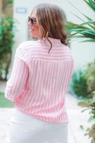 lightweight pink and white striped button-up top with a collared neckline, a chest pocket, a subtle back yoke detail, high-low hem, and no stretch