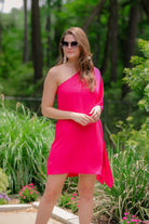 a magenta one-shoulder mini dress with an asymmetrical neckline and a draping, billowy body creating a relaxed silhouette 