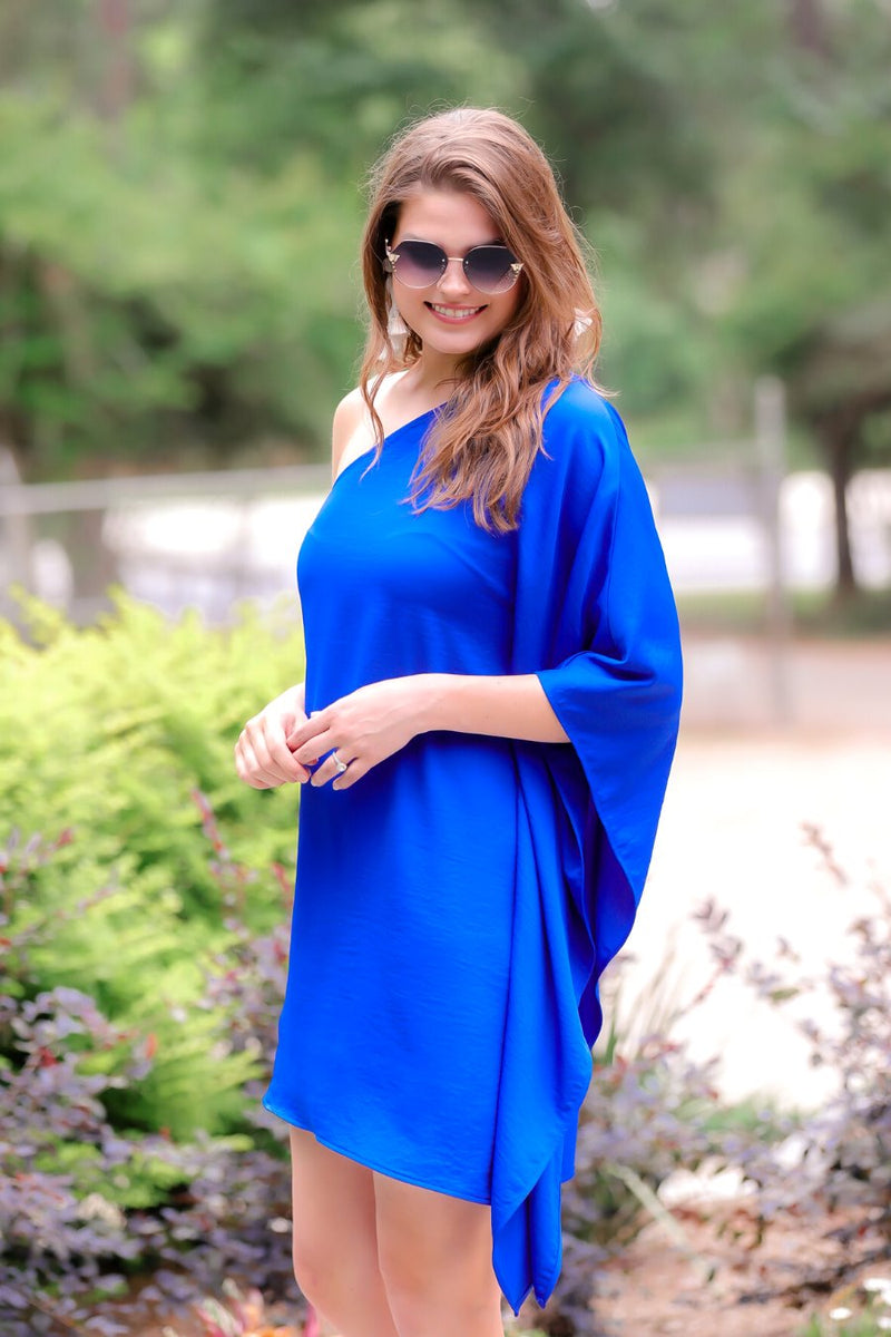 a royal blue one-shoulder mini dress with an asymmetrical neckline and a draping, billowy body creating a relaxed silhouette 