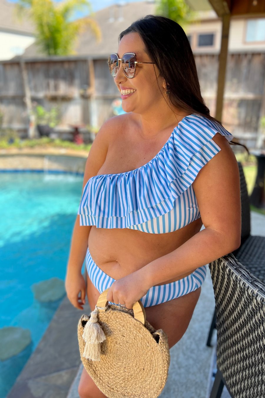 two-piece swimsuit with a ruffle bikini crop top and a full coverage high-waisted bottom on a blue and white striped pattern