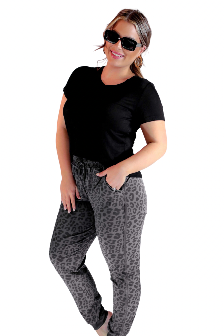 a mid-rise relaxed fit joggers with side pockets and a tie waist drawstring, designed on a black-on-black leopard pattern print and black base