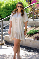 button-up front, a collared v-cut neckline, loose half sleeves, side pockets, and a tiered ruffled hemline