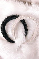a soft, structured headband adorned with beautifully clustered pearls in varying sizes in black and ivory