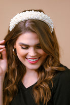 a soft, structured headband adorned with beautifully clustered pearls in varying sizes in ivory