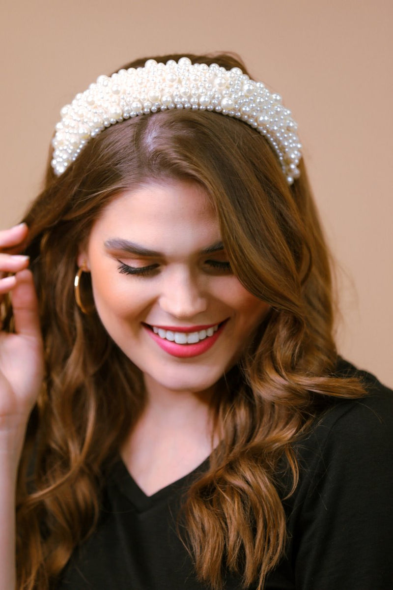 a soft, structured headband adorned with beautifully clustered pearls in varying sizes in ivory