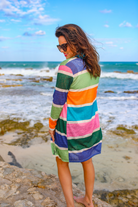 a lightweight open-front cardigan with a relaxed fit, breathable knit fabric, and bold multicolored vertical stripe design in dusty pink, kelly green, periwinkle, sage green, tangerine, and teal on a cream base
