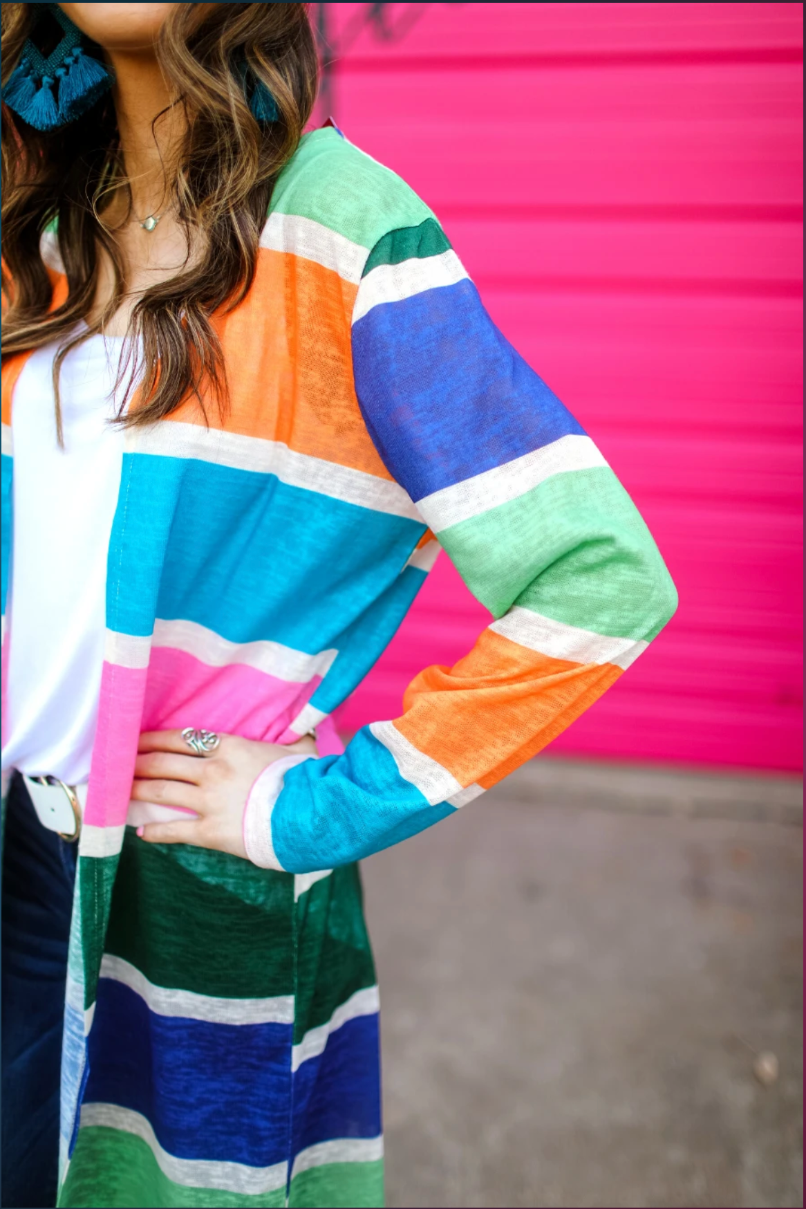 a lightweight open-front cardigan with a relaxed fit, breathable knit fabric, and bold multicolored vertical stripe design in dusty pink, kelly green, periwinkle, sage green, tangerine, and teal on a cream base