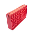 a waterproof red silicone zippered pencil case with poppable bubbles, a discreet popping sound, a comfortable touch, compact storage for small essentials, and an endlessly reusable, dishwasher-safe design for versatile daily use