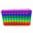 a waterproof rainbow silicone zippered pencil case with poppable bubbles, a discreet popping sound, a comfortable touch, compact storage for small essentials, and an endlessly reusable, dishwasher-safe design for versatile daily use