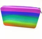 a waterproof rainbow silicone zippered pencil case with poppable bubbles, a discreet popping sound, a comfortable touch, compact storage for small essentials, and an endlessly reusable, dishwasher-safe design for versatile daily use