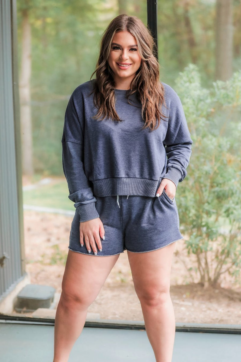 vintage wash navy long sleeve top and short set with side pockets, an elastic drawstring waistband, and a relaxed fit on a super soft material